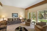 Well-appointed living room with plenty of seating and access to the backyard